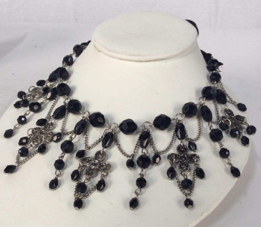 Black Beaded Gothic Victorian Style Necklace: Black beaded Gothic Victorian Style Collar Necklace. Necklace has silver toned chain with black beads and velvet fabric tie closure. Necklace strand approximately 13 inches in length, can be adjusted.