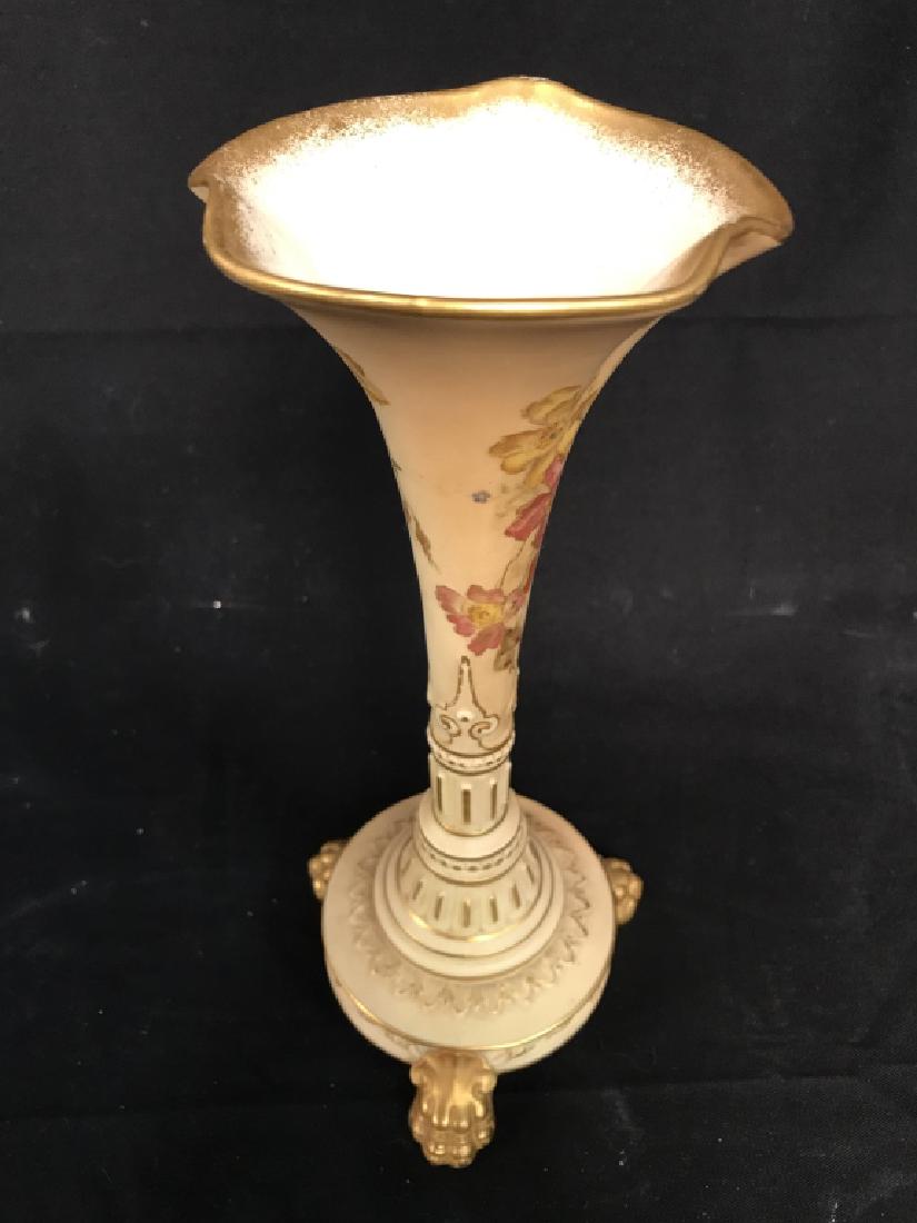 ROYAL WORCESTER Intricately Painted Porcelain Vase: Underside is marked ROYAL WORCESTER. Piece has 3 gold toned lion claw style feet. Contains intricately painted floral & leaf detail. Measures approx 9 inches tall 4 inches wide. 6
