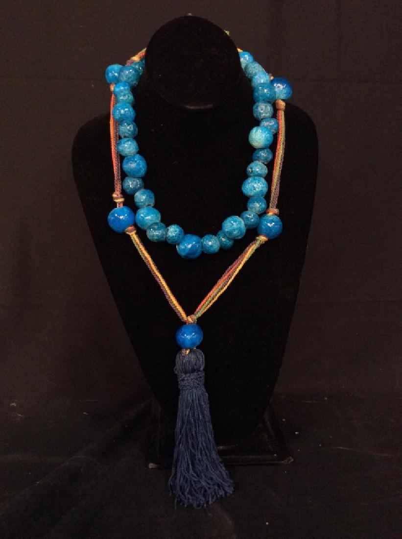 Lot 2 Bright Blue Glazed Beaded Necklaces: Lot 2 Bright Blue Glazed Beaded Necklaces, one with multi stranded colorful thread and blue toned tassel design, bright blue toned glazed beads, possibly ceramic, possibly stone, organic shapes, porou