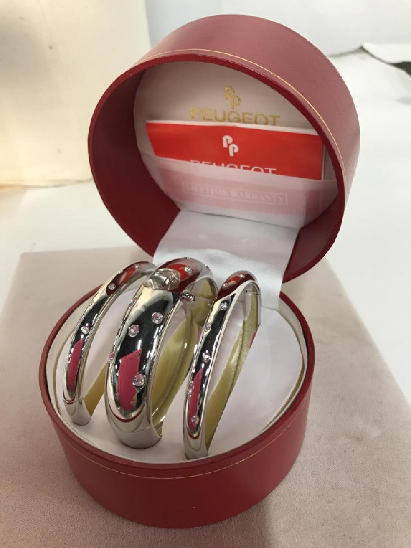 Peugeot Bangle And Watch Set w Box: Peugeot Bangle And Watch Set, original red Box, two silver toned Rhinestone bangles, and a matching watch bangle, each 2 7/8 in diameter, watch face marked quartz and Peugeot, Ladies Costume Accessori