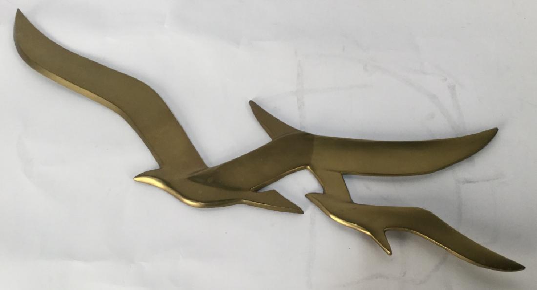 Mid-Century Modern Wall Art Of Birds: Mid-Century modern Wall Art Of birds abstracted. Art is brass in tone. Reverse side is marked with ‘A’s. Approximately 8 inches in height by 26 inches in width. Decorative wall art / wall hanging 