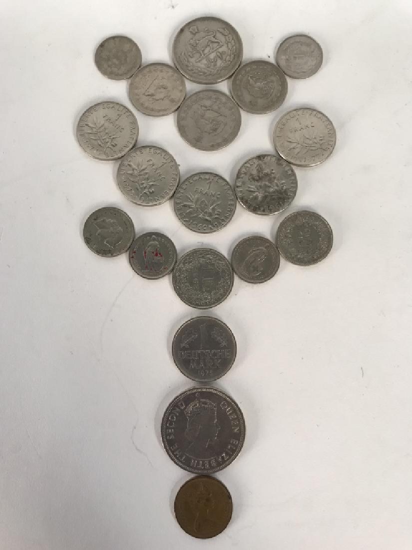 Lot 19 Assorted International Coins: Lot includes 5 Francs, 1 English penny, 1 Hong Kong dollar, 1 Deutsche Mark, 5 Swiss coins , & 6 coins which appear to be middle eastern. Largest coin measures approx 1.5 inches. 6