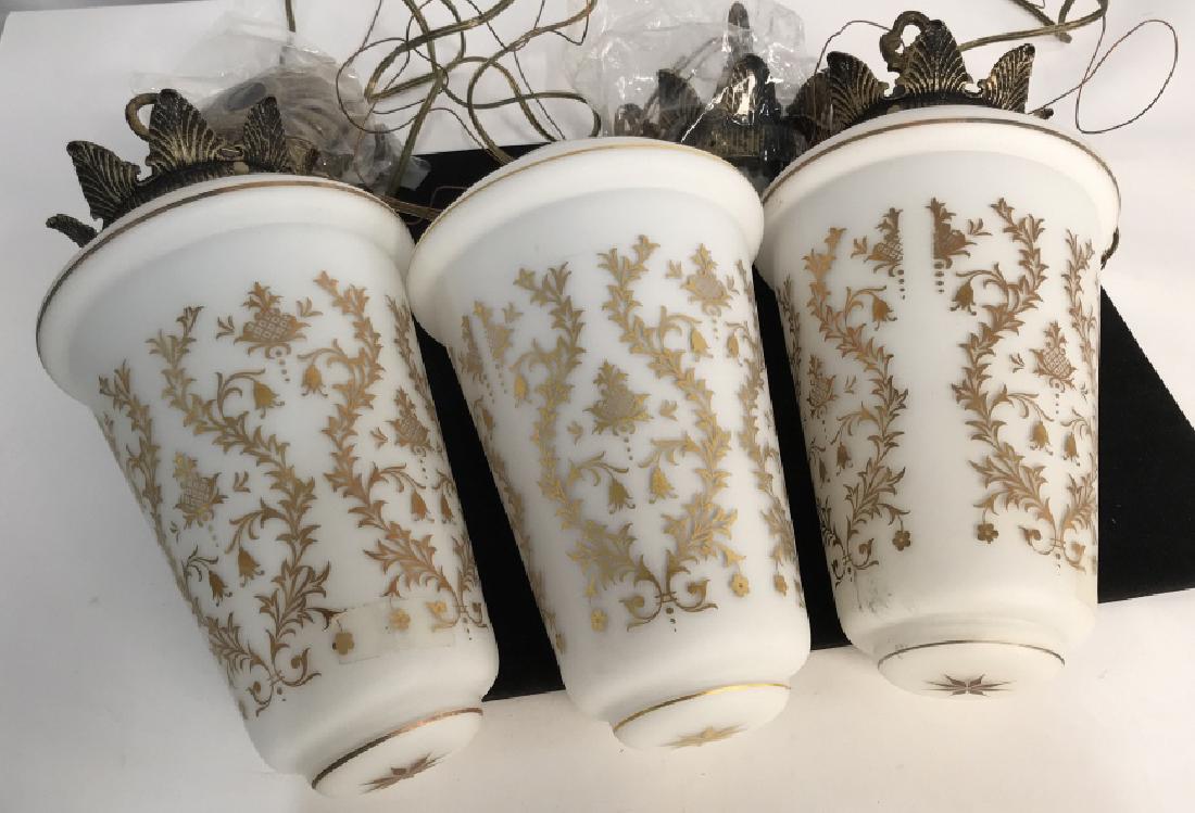 Vintage Style Milk Glass Hanging Lights, France: Vintage Style Milk Glass 3 Hanging Lights, formed elongated acorns with gold accents, Antiqued Brass toned hardware, all stamped VV Made in France, each overall 15 in x7in widest part, good condition,
