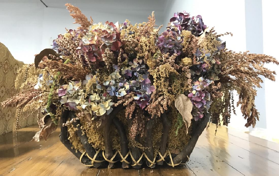 Primitive Style Handled Basket W Dried Flowers: Primitive Style Handled Basket W Dried Flowers. A primitive style basket w top handle and a mix of dried wild flowers, Moss and hydrangeas. Measures approx 30 inches wide x 18 inches tall x 18 inches 