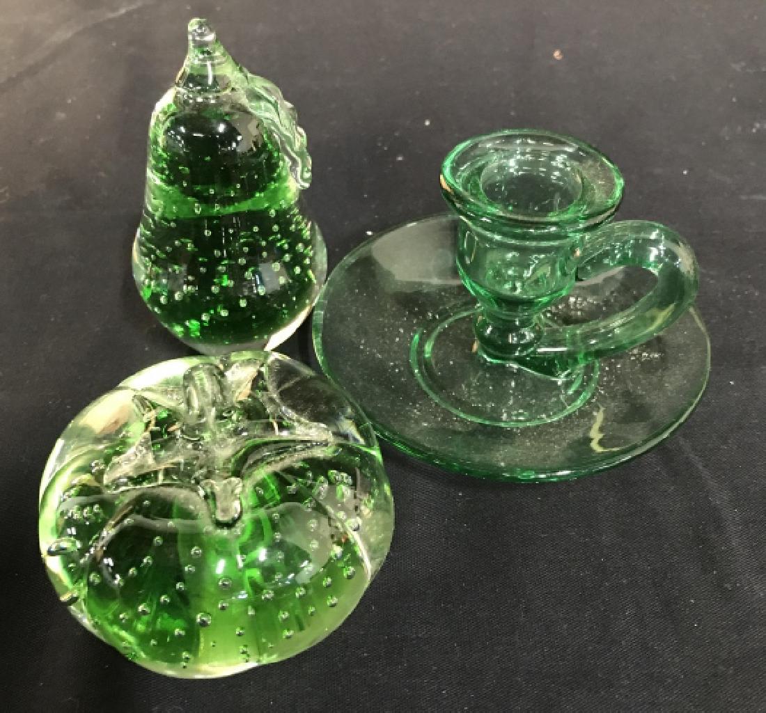 Green Glass Paperweights And Candlestick: Green crystal glass tableware, table top accessories, green candlestick with thumb carry, and green glass apple and green glass solid pear, tallest measures 4 inches, tableware, decorative accessories