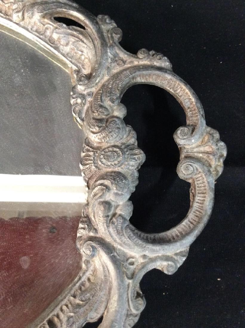 Silver Toned Metal Framed Mirror Vanity Tray: Silver Toned Metal Framed Mirror Vanity Tray. Mirror tray with silver toned metal frame with ornate filigree design. Measures approx 19 in by 11 in. Tableware, tray, vanity tray, decorative accessory.