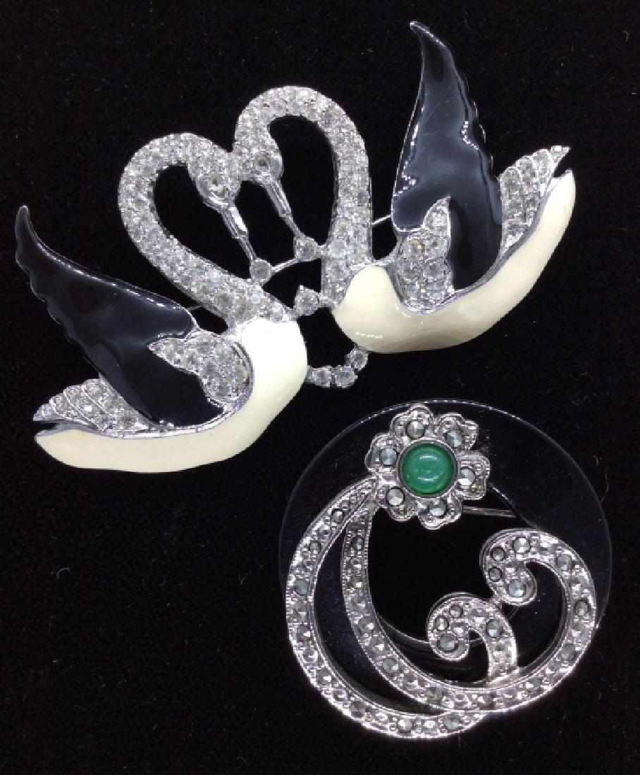 Lot 2 Vintage Rhinestone Bejeweled Pins: Lot 2 Vintage Rhinestone Bejeweled Pins. One brooch pin with black toned circular stone style piece, with silver toned metal curved filigree design overlay decorated with rhinestones, marcasite and gr