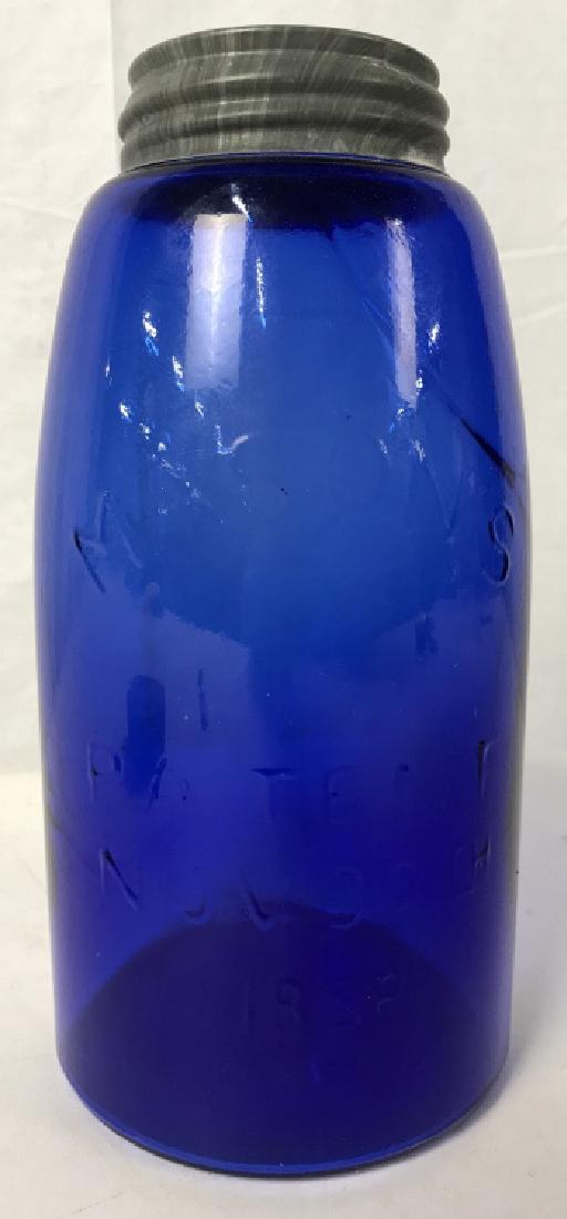 Cobalt Blue Glass Mason’s Jar W Lid: Cobalt blue glass Mason’s jar with lid. On Jar reads ‘Mason’s Patent Nov 30th 1858’. Approx 9 inches in height by 4.5 inches in diameter. Some discoloration on lid. Vintage collectible glass c