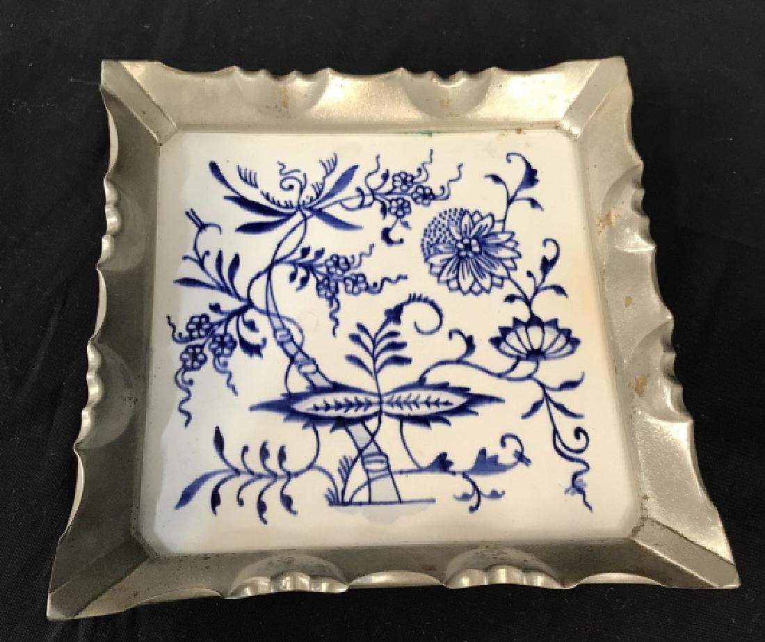 Blue and White Tile Trinket Dish, Silver tone: Blue and white tile trinket / catch all / jewelry dish, with silver metallic tone rim. Floral motif on tile. Approx 6.75 inches squared in length and width, 1 inch in depth. Decorative tabletop / vani