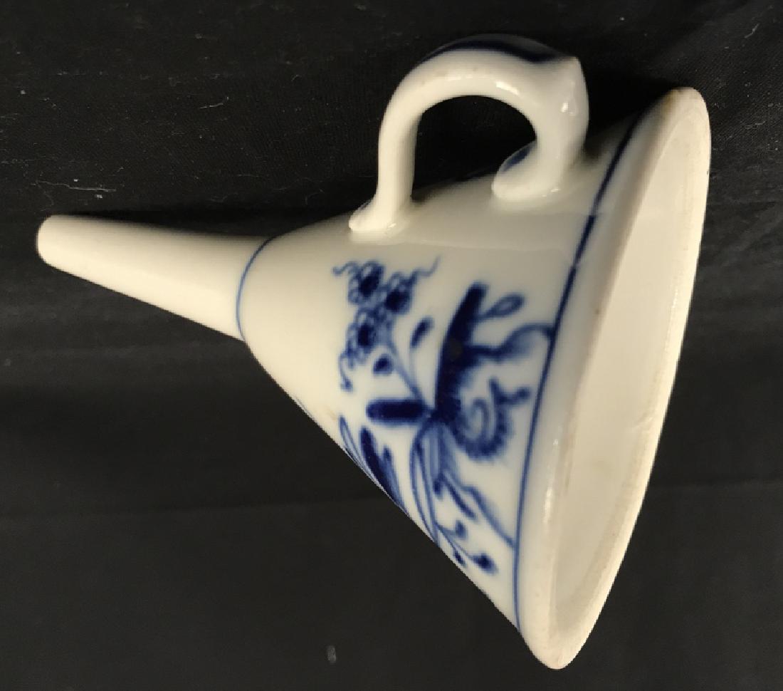 Blue and White Ceramic Funnel Kitchenware: Blue and white tone ceramic funnel. Funnel has handle. Blue floral motif around exterior surface. Approx 5.5 inches in height, 3.75 inches in diameter. Ceramic kitchenware / cooking baking utensils. 7