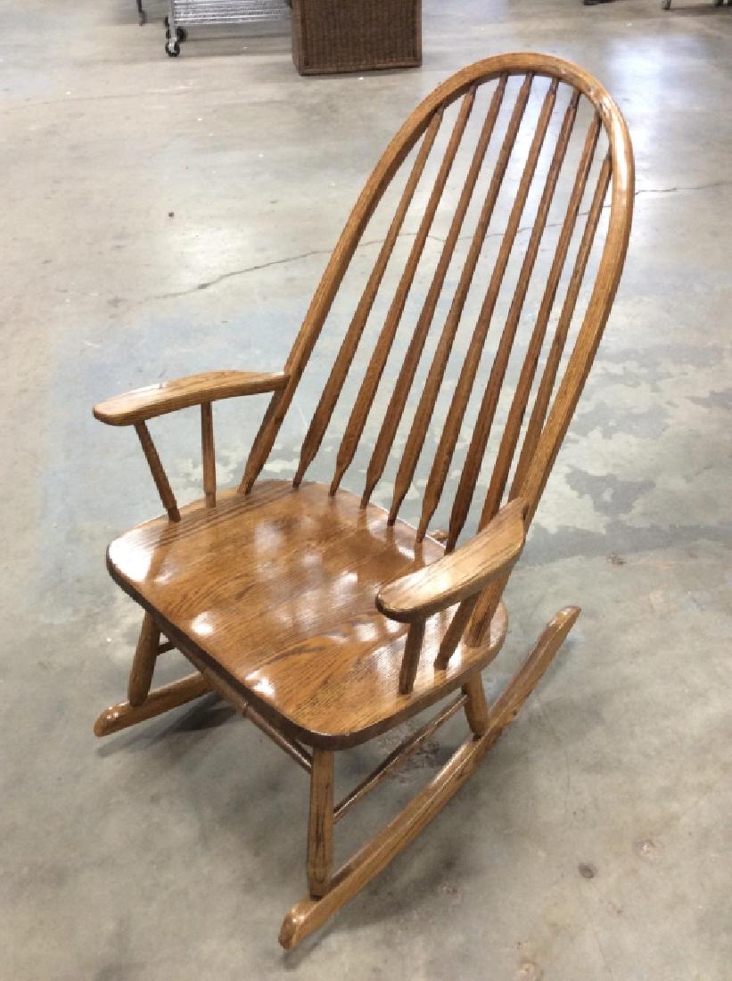 Wooden Arts and Crafts Style Rocking Chair: Wooden Rocking Chair. Light toned finished wooden rocking chair, Spindle back chair, dome back, home furnishings, living room furniture, home accessory. Measures approx 44 in by 27 in by 31 in long. P