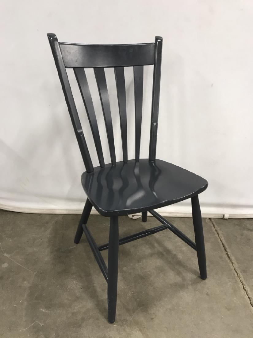 Navy / Prussian Blue Tone Wooden Chair: Wooden chair painted in navy / deep Prussian blue. Some minor chips in paint. Approx 37 inches in height by 19 inches in width by 15.75 inches in depth. Interior decor / dining room kitchen seating / 