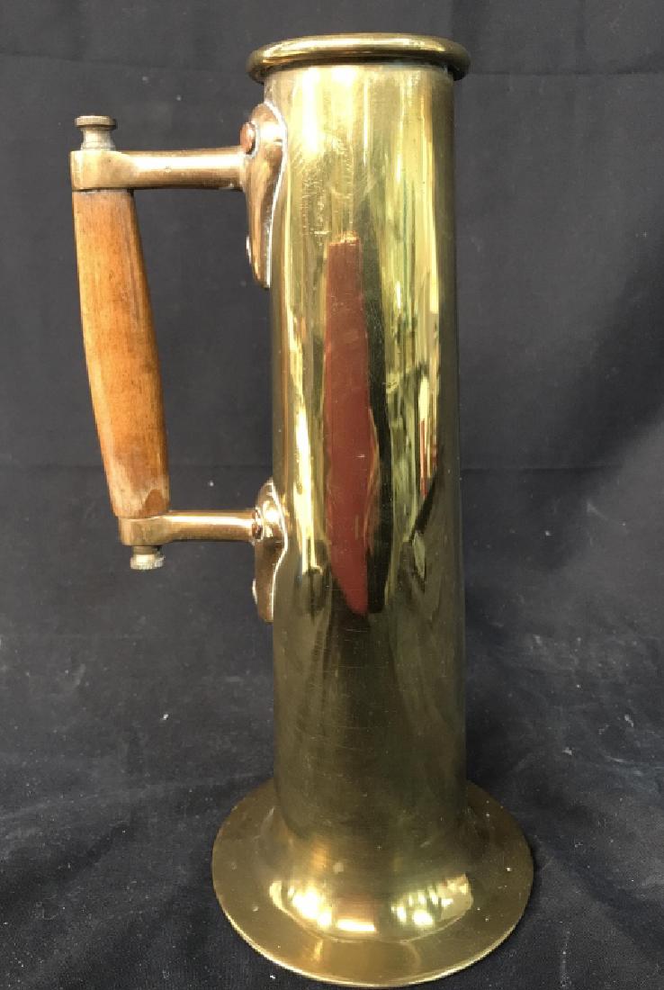 Brass Tankard Tall Wood Handle Primitive Mug: Piece appears to possibly be antique. Piece is gold toned and brass. Handle is wooden. Measures approx 11.5 inches tall 6 inches wide with handle. Contains some wear consistent with age. decorative ac