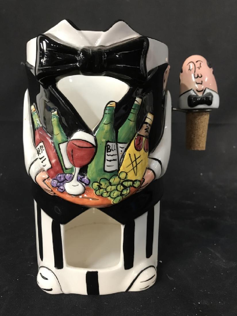 NANTUCKET HOME Porcelain Wine Coaster W Cork: Underside of coaster reads NANTUCKET HOME. Piece is possibly hand painted. Resembles shape of butler holding bottles of wine. Wine coaster, barware, bar accessory, drinking accessories, decorative tab