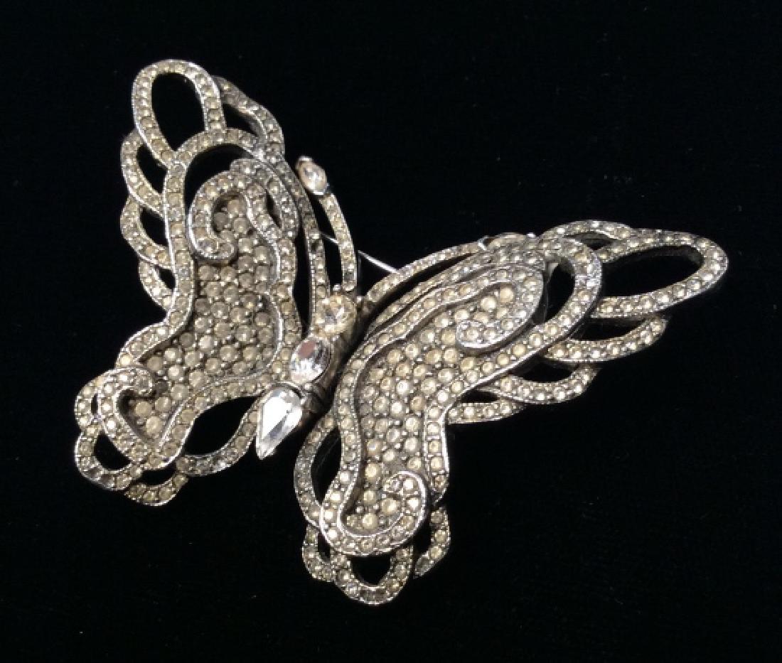 Ciner Silver Toned And Rhinestone Brooch: Ciner Silver Toned And Rhinestone Brooch In the form of a butterfly, marked on reverse Ciner, measures approx 2 inches tall x 2.75 inches wide, no condition issues noted, Costume Jewelry, Estate Jewel
