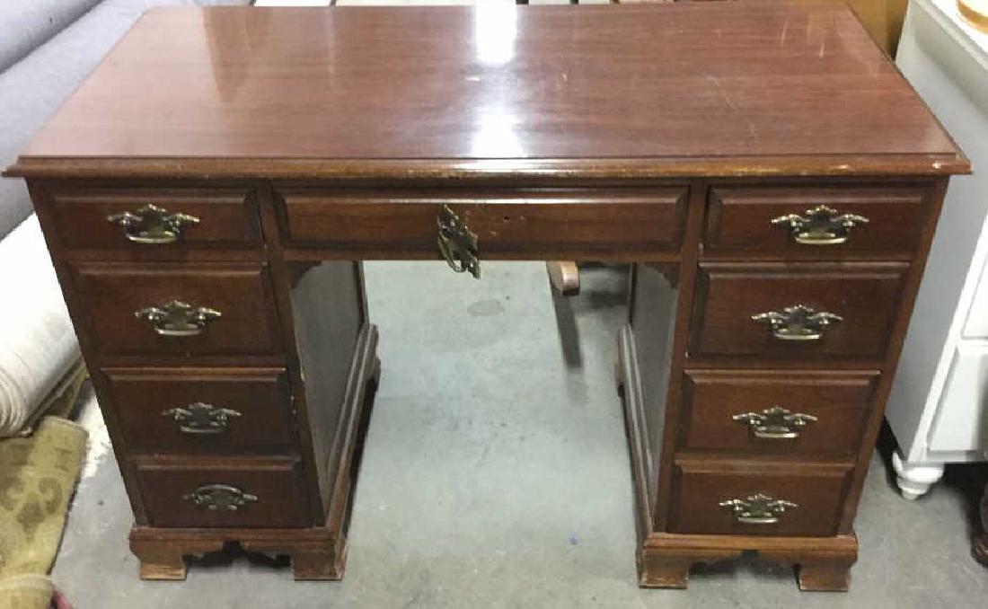 Wood and Brass 7 Drawer Home Office Desk: Wooden 7 Drawer Office Desk. Contains Gold toned handles. Some surface wear and chips, middle drawer handle needs to be repaired. Bottom appears to be carved. Office desk, Executive desk, Home office