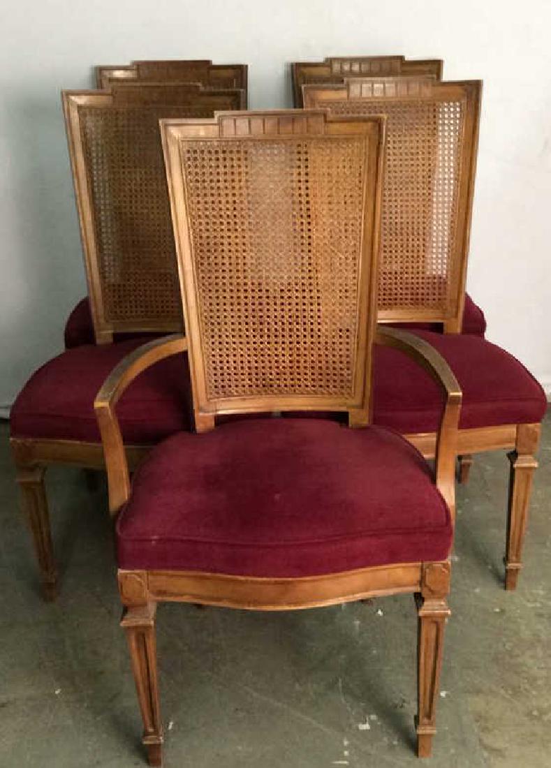 Set 4 Cushioned Caned Dining Chairs: Lot includes 3 side chairs and 1 end chair. Chairs have dark magenta, maroon toned cushions and caning on backrests. Some chairs have some imperfections to caning. Chairs have some minor wear and surf