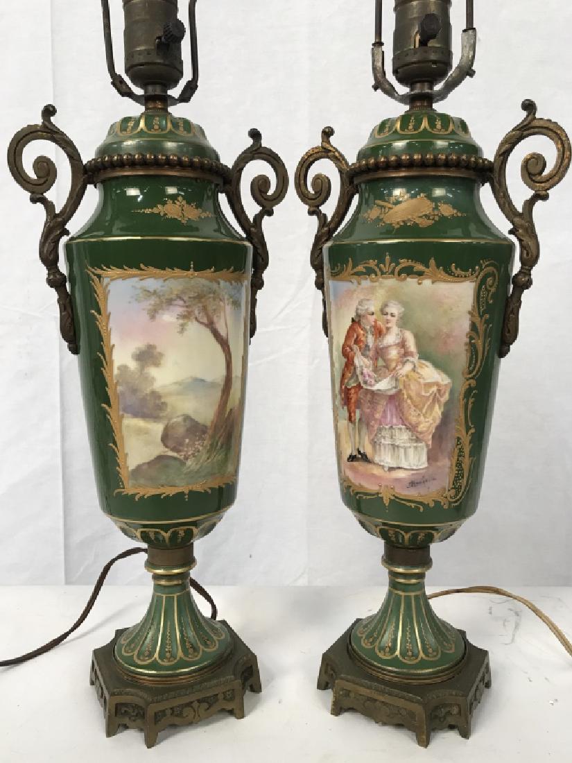 Pair of French Sevres Style Table Lamps: Pair of Sevres style French electrified table lamps. Lamps are moss green in tone with painted scenes of a courting couple on one side, and trees in landscape on reverse side. Courting scenes are Sign