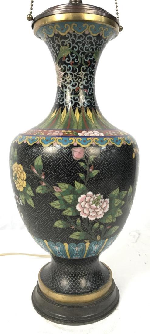 Asian Decorative Cloisonne Metal Table Lamp: Asian decorative metal cloisonne electrified table lamp. Lamp body features colorful floral designs and patterns against a black tone backdrop. Minor imperfection in the cloisonne work, where it seems