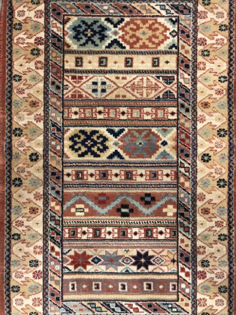 ABC Home & Carpet Handmade Wool Rug: Tag on underside reads ABC New York SAMARKAND. Contains tones of tan, navy, orange, teal, & beige. Contains fringes. Some fringes are missing. Home accessory, home decor, carpet, rug, Measures approx