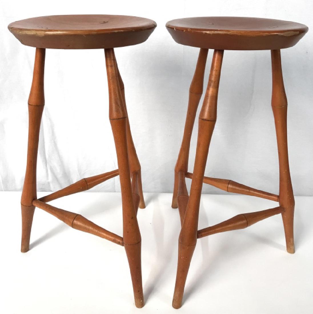 Pair Of Vintage David T Smith & CO Stools: Pair Of Vintage David T Smith & CO Triangular Base Stools In orange toned stain with turned legs and stretchers. Some surface wear and scratches due to age and use. Measures approx 26 inches tall x 16