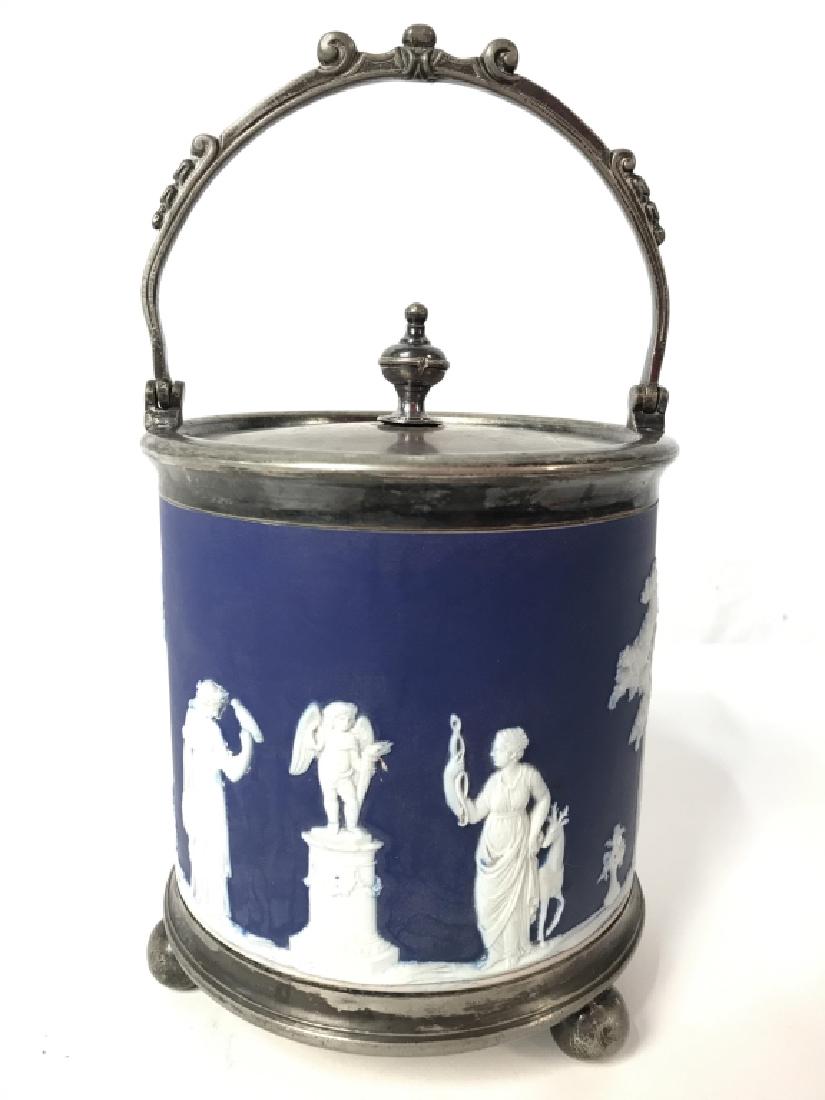 Blue Toned WEDGWOOD Ice Bucket W Handle: Underside is marked WEDGWOOD. Piece is blue and white toned with silver toned lid, handle & feet. Measures approx 10 inches tall with handle 5.5 inches wide. Decorative tableware, tabletop accessory, 