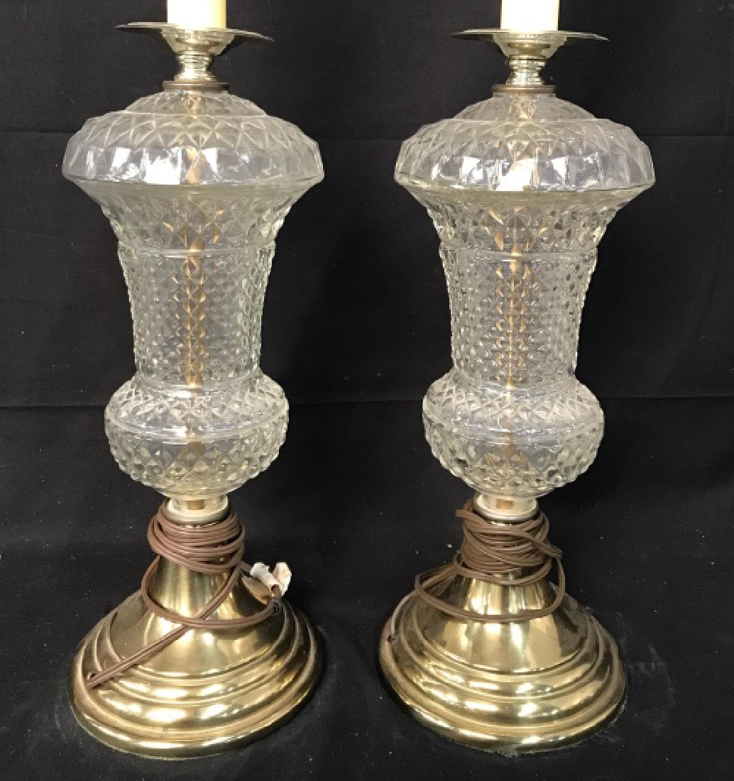 Pair Cut Glass Side Table Lamps: Lot include 2 Cut Glass Lamps. Bases are gold toned and appear to be brass. Tops of lamps resembles Candlestick shape. Each measures approx 21.5 inches tall 6 inches wide. Home lighting, home accessor