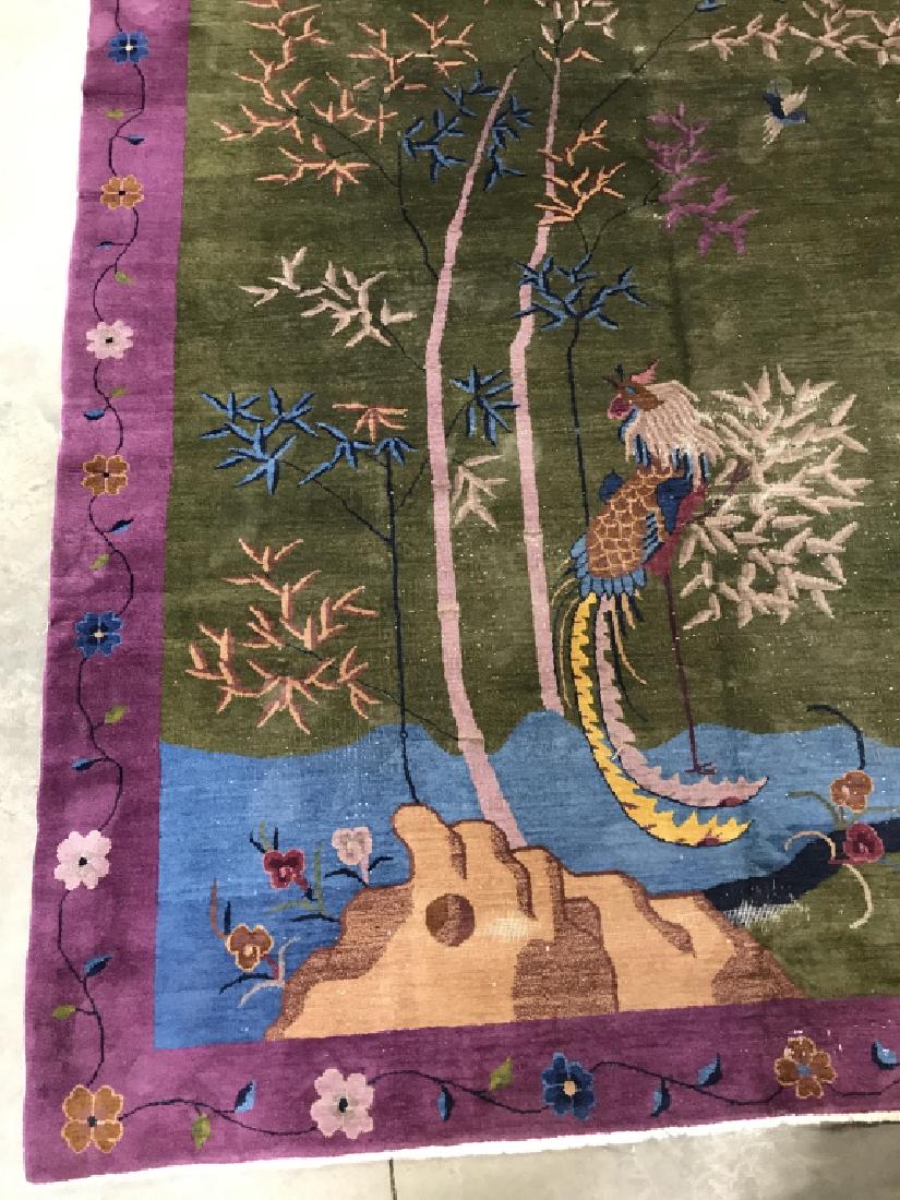 Vintage Possibly Antique Chinese Art Deco Carpet: Vintage possibly antique Chinese Art Deco Wool Pile Carpet with multicolored tree and bird center design over hunter green toned background and purple toned boarder with floral and vine motif. Measure
