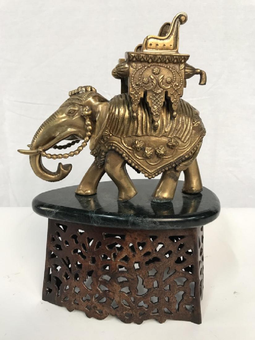 Brass Elephant Chariot Sculptural Iron Cover: Brass elephant chariot sculpture on a deep green tone stone base. Brass and stone sits atop a metal grate in the shape of an iron, possibly to be used as a decorative cover for a coal iron. Approx 13 