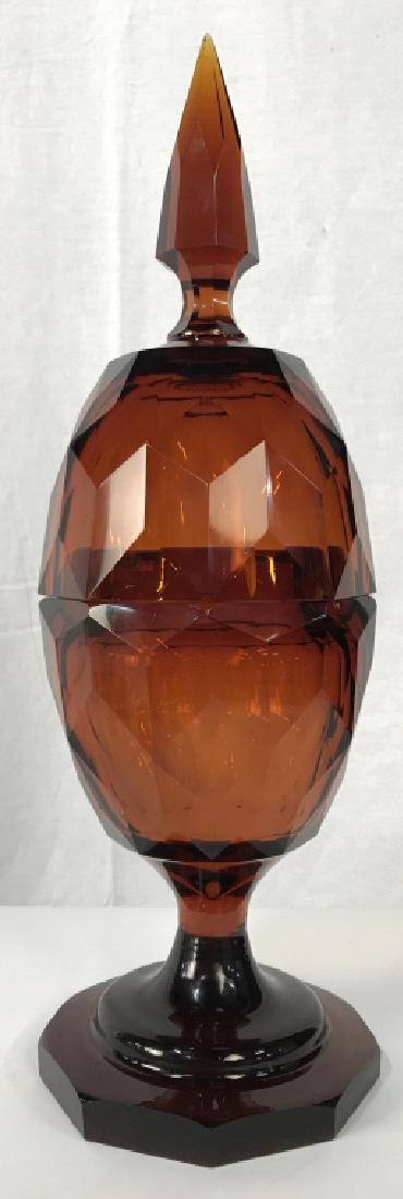 Statement Vintage Amber Cut Glass Dish W Lid: Statement Vintage Amber Cut Glass egg shaped dish with lid. Lid extends into spear top. Dish is heavy in weight. Some surface wear, including a subtle scrape in glass on tip of spear. Approximately 20