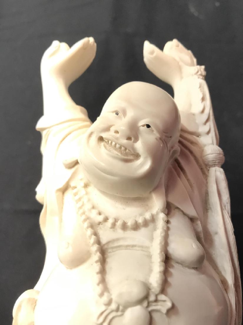 Cream Toned Resin Buddha Figure: Figure is cream toned. Appears to be Resin. Depicts a standing Buddha with hands up in the air. Measures approx 8 inches tall 3.5 inches wide. Has some minor chips. Asian arts and crafts, oriental dec