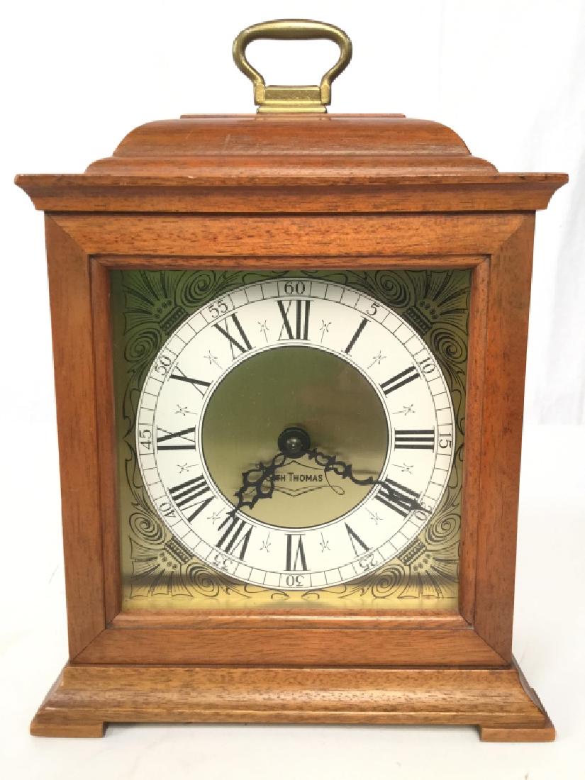 SETH THOMAS Wooden Mantel Clock: Clockface is marked SETH THOMAS. Appears to be vintage. Clockface is black, white, and gold toned. Tag on backside reads SETH THOMAS CLOCKS THOMASTON CONN USA. Measures approx 10.5 inches tall 7 inche