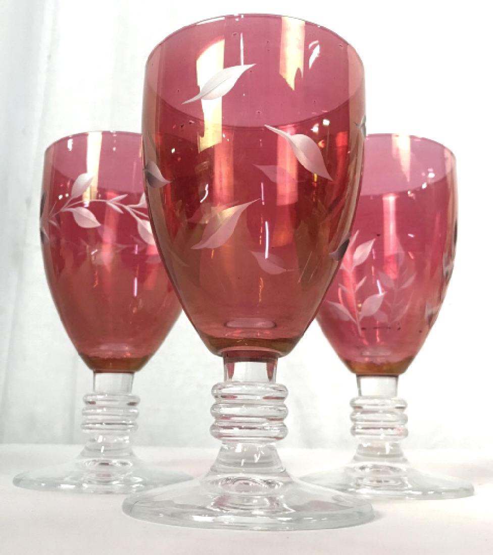 Lot 4 Bohemian Cranberry Wine Glasses: Wine glasses are cranberry toned with frosted leaf and vine detail. Measures approx 6 inches tall 3 inches wide. Bohemian glass, art glass wine glasses, cranberry glasses. stemware, barware, glassware