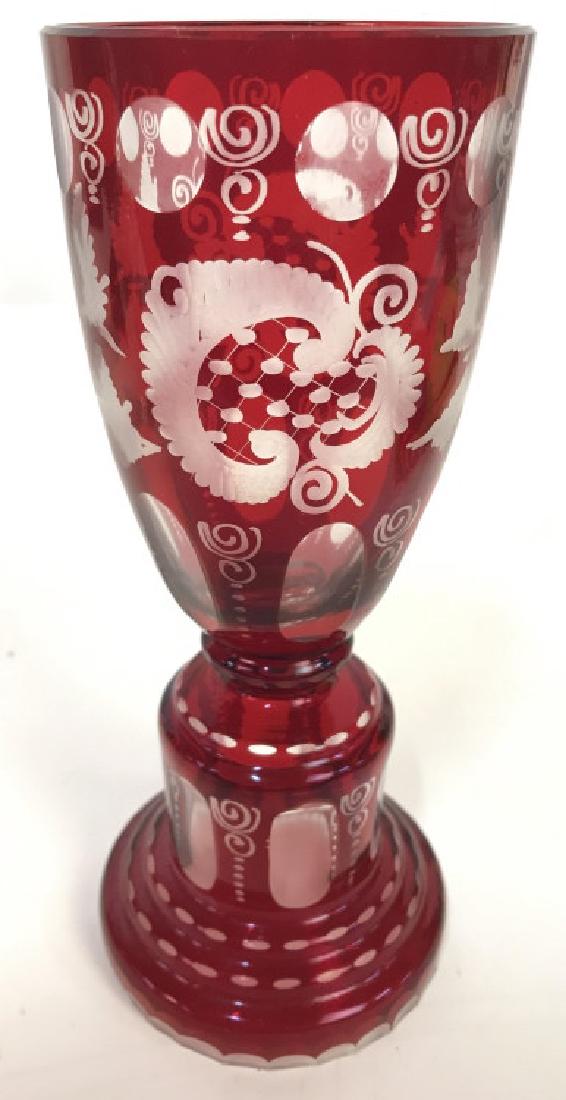 Bohemian Cranberry Art Glass Chalice: Chalice is cranberry toned. Contains intricate frosted detail around chalice. cranberry Glass, Art Glass, cranberry art glass, art glass chalice. Chalice is Pedestaled. Measures approx 8.5 inches tall