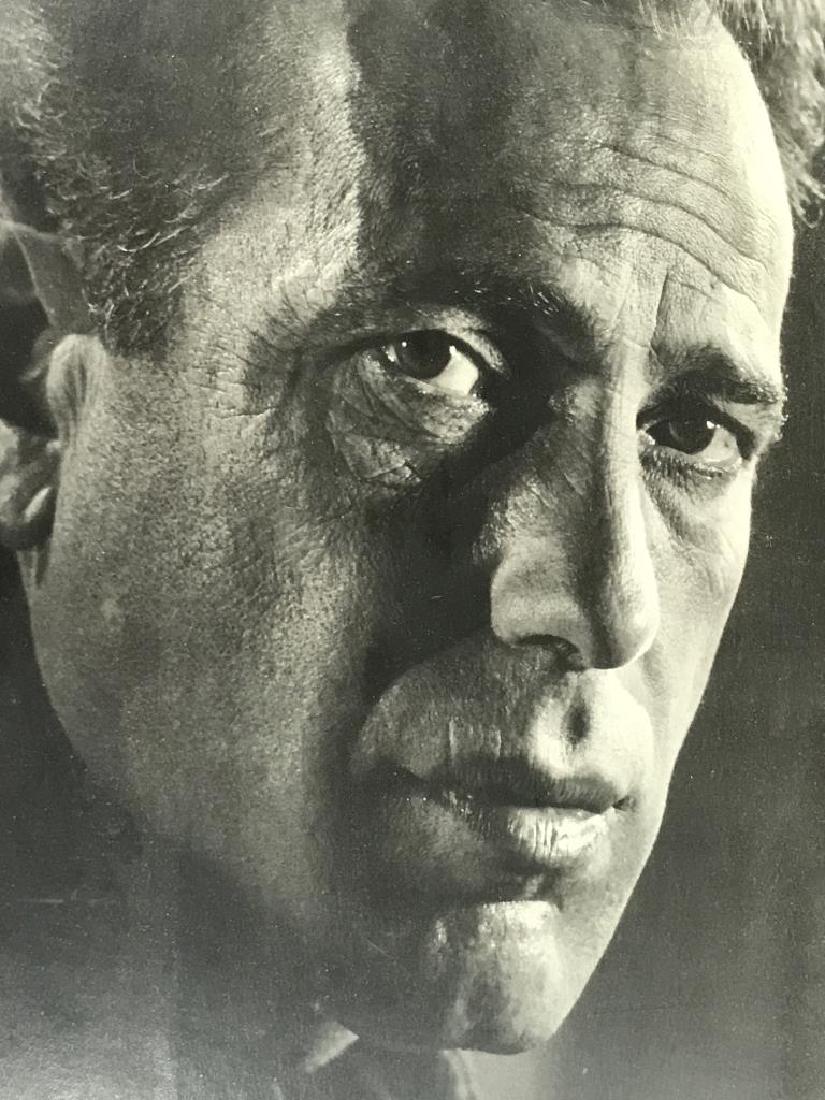 Photograph of Humphrey Bogart,c. 1944: black and white photograph of Humphrey Bogart by photographer Philippe Halsman from 1944. Photograph is a headshot portrait of Bogart. Artwork is matted and in silver tone metal frame. Approx 19.25 in