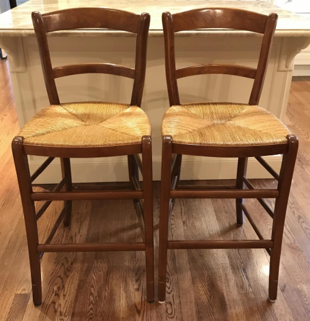 Pair French Wooden Bar Stools W Rushed Seats: Pair French Wooden Bar Stools W Rushed Seats, marked on underside with illegible signature and FRANCE, Measures approx 39 inches tall x 17 inches wide x 16 inches deep, minor surface scratches to legs