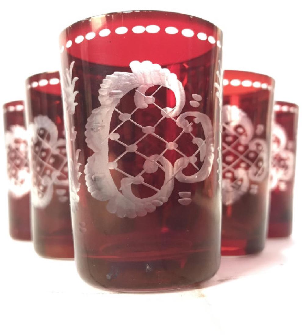 Set 6 Cranberry Glass Shot Glasses: Lot includes 6 cranberry toned shot glasses. Each have frosted geometric, floral, tree and crane detail. Cranberry Glass, Bohemian Shot Glasses, red Shot Glasses, frosted shot glasses, intricate shot 