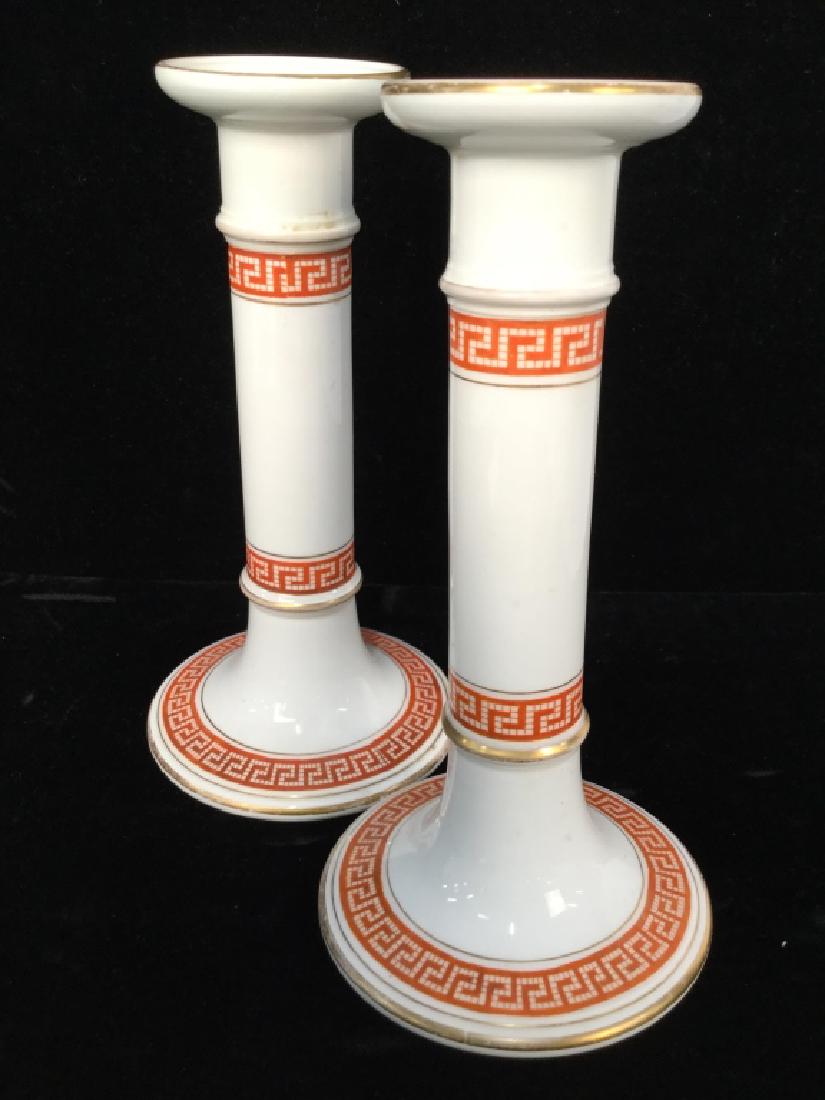 Pair White Tined Porcelain Candlesticks: Pair White Tined Porcelain Candlesticks W red toned geometric design and gold toned trim details. Some surface wear including wear to paint. Measures approx 7 in By 4 in . Collectible Tableware, Table
