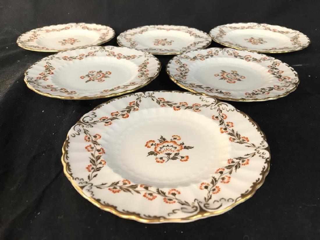 Lot 8 ROYAL CROWN DERBY Porcelain Butter Pats: Lot includes 8 butter pats. Each is marked ROYAL CROWN DERBY MADE IN ENGLAND “BOURBONNAIS”. Measures approx 6.5 inches wide. Contains gold and orange toned floral and leaf detail. Tableware, bread