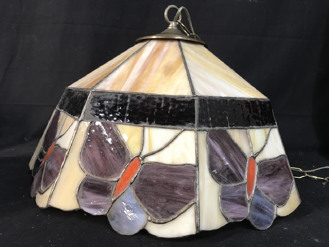 Tiffany Style Butterfly Stained Glass Chandelier: Tiffany style butterfly stained glass pendant chandelier. Pendant is sand tone with purple and orange tone butterfly details along the lower border band. Pendant is Approx 11.5 inches in height by 17.