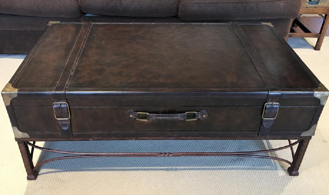Leather Trunk Style Coffee Table W Metal Base: Dark brown leather style trunk Coffee Table W Metal Base, brass toned protective corners and buckles, very light surface wear and scratches, trunk does not open, measures approximately 45 inches long 