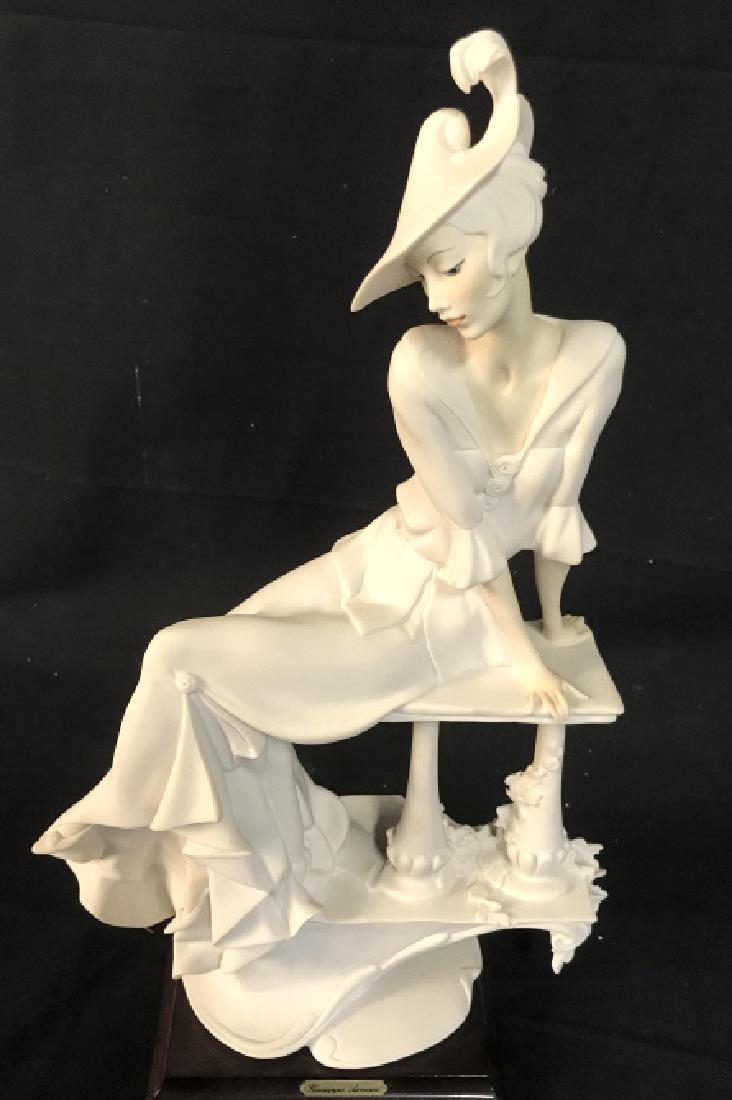 Signed GIUSEPPE ARMANI ‘91 Porcelain Figurine: Signed GIUSEPPE ARMANI 1991 porcelain figurine of an Art Deco seated woman on bench, made in Florence, Italy. Signed and stamped with ‘N’ On reverse side of figure. Figure is white in tone with so