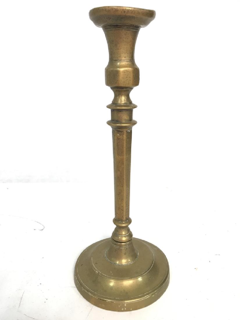 Antique Brass Candlestick: Candlestick is antique and gold toned. Contains some wear due to age. In antique condition. Measures approx 11.5 inches tall 5 inches wide. decorative accessory, tableware, tabletop decor home accesso