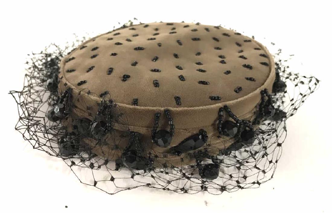 MILDRED MILLINERY & BOUTIQUE Hat: Top of box reads MILDRED MILLINERY & BOUTIQUE. Hat is light brown toned with black toned netting and faux crystals. Measures approx 6 inches wide 1.75 inches tall. Vintage hat, millinery hat, Mildred 