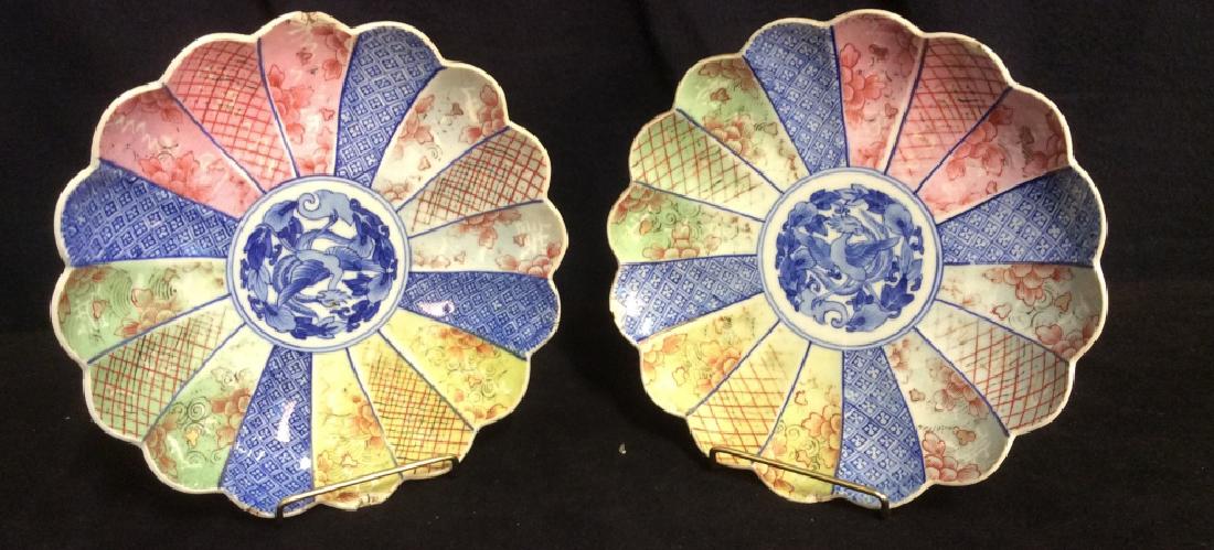 Pair of Porcelain Painted Plates: Pair of porcelain painted plates. Plates are hand painted. Tones of red, green, yellow, pink and blue. in pinwheel or petal style, some chinoiserie detailing design, Matching set. Measures 9inches. De