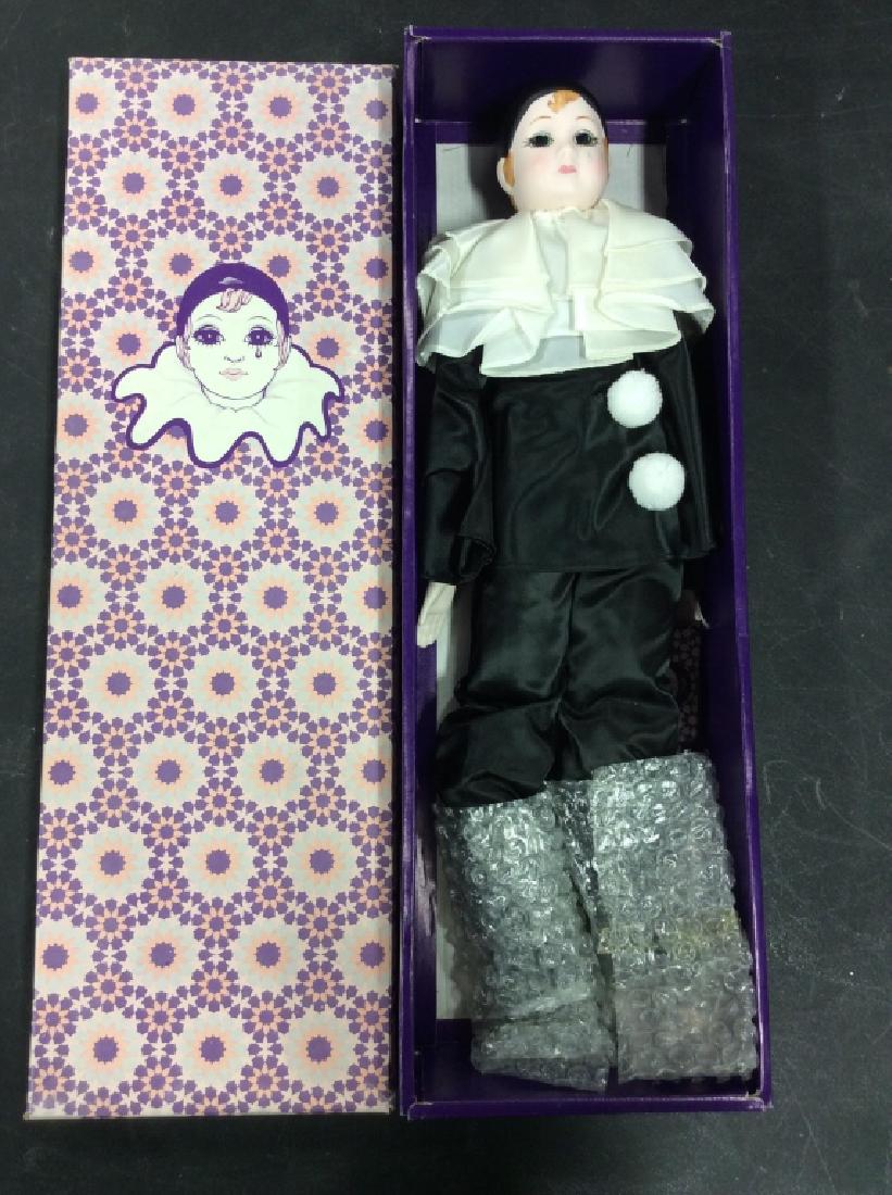 Vintage Collectible RUSS Porcelain Doll w Box: Vintage collectible RUSS porcelain doll. Handpainted and clothed in black jester / harlequin / clown attire. Comes with original box and tags. Box has been opened. Approximately 18 inches in length. P