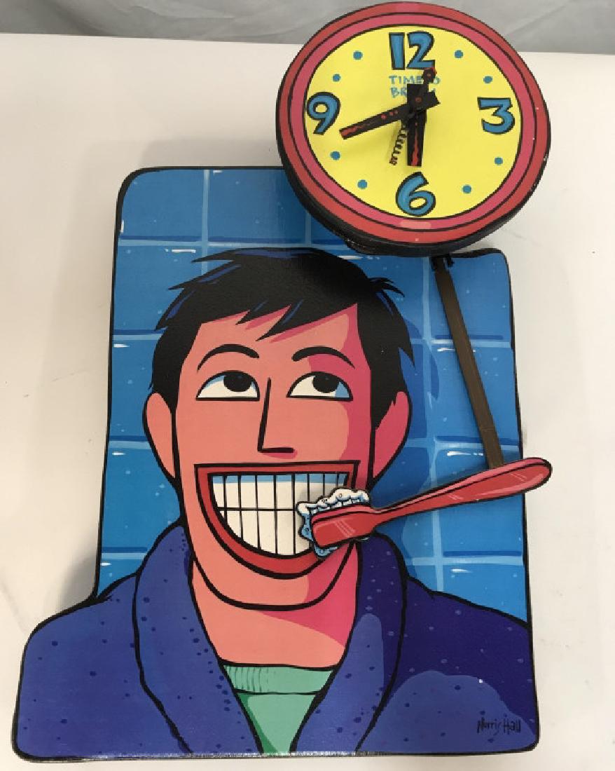 NORRIS HALL Collectible ‘Time to Brush’ 3D Clock: NORRIS HALL collectible ‘time to brush’ clock. Clock features an illustrated man below a clock, with a toothbrush as the pendulum. According to the Norris Hall website, these novelty clocks are no
