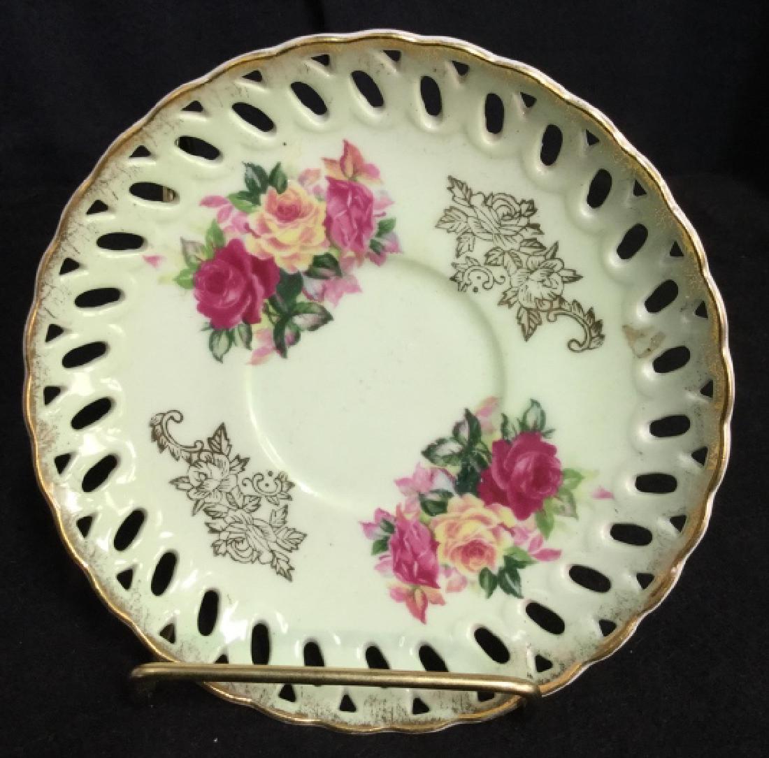 Nippon Reticulated Painted Pierced Porcelain Plate: Plate is hand painted porcelain. Plate include cut out along outside border. Made in japan. porcelain plate. green, gold, pink, yellow. Measures 6inches. decorative table top accessory, display plate