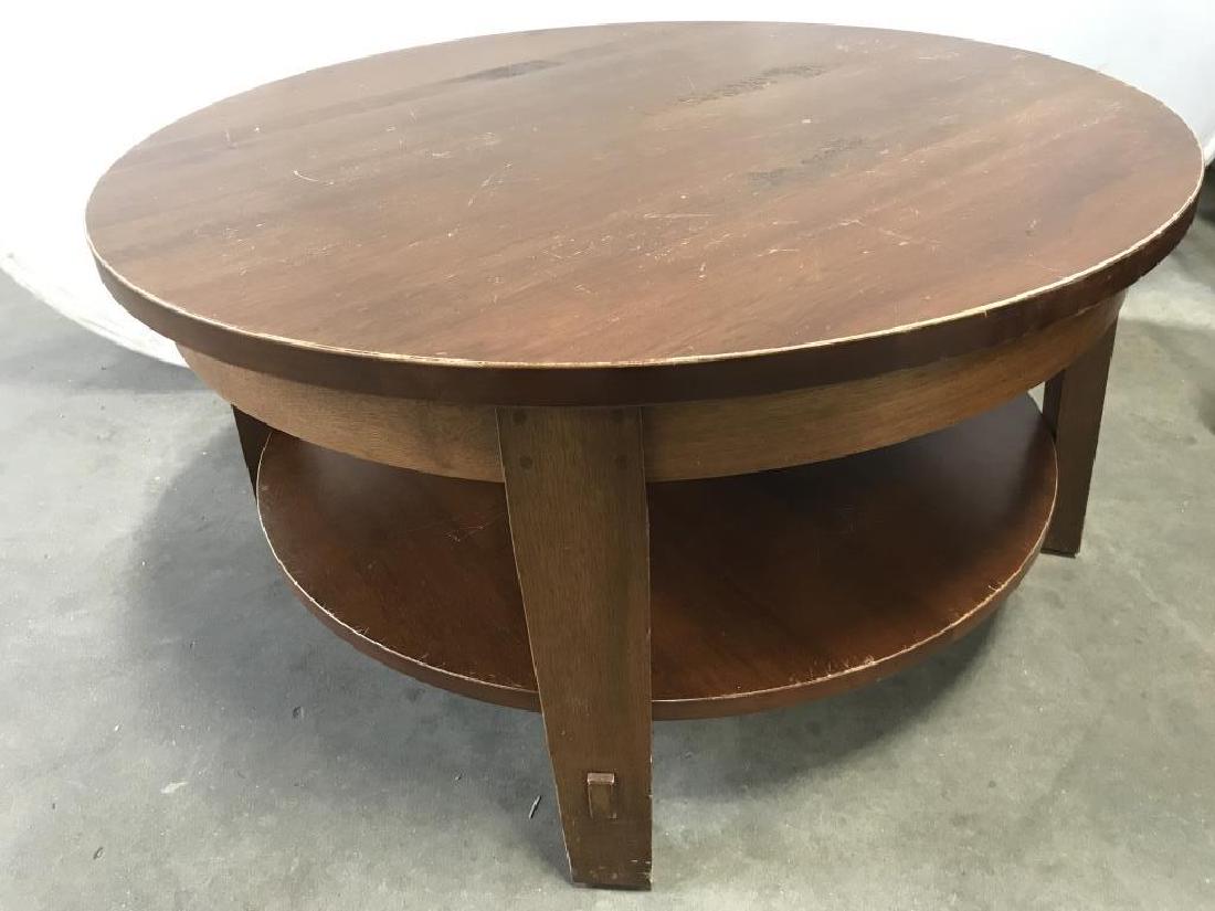 Vintage Round Tiered Wooden Coffee Table: Coffee table is wooden & light brown toned. Contains 4 legs. Measures approx 36 inches wide, 18 inches tall. Contains evident Scratches & wear. Living room furniture, home furnishings, coffee table, l