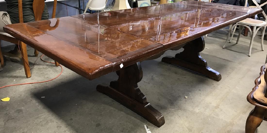 High Gloss Stained Pine Trestle Dining Table: High Gloss Dark Stained Pine Trestle Dining Table. Some nicks and scratches to base. Measures approx 100 inches long x 38 inches wide x 29 inches tall. Dining Room Furniture. Large Dining Table. Holid